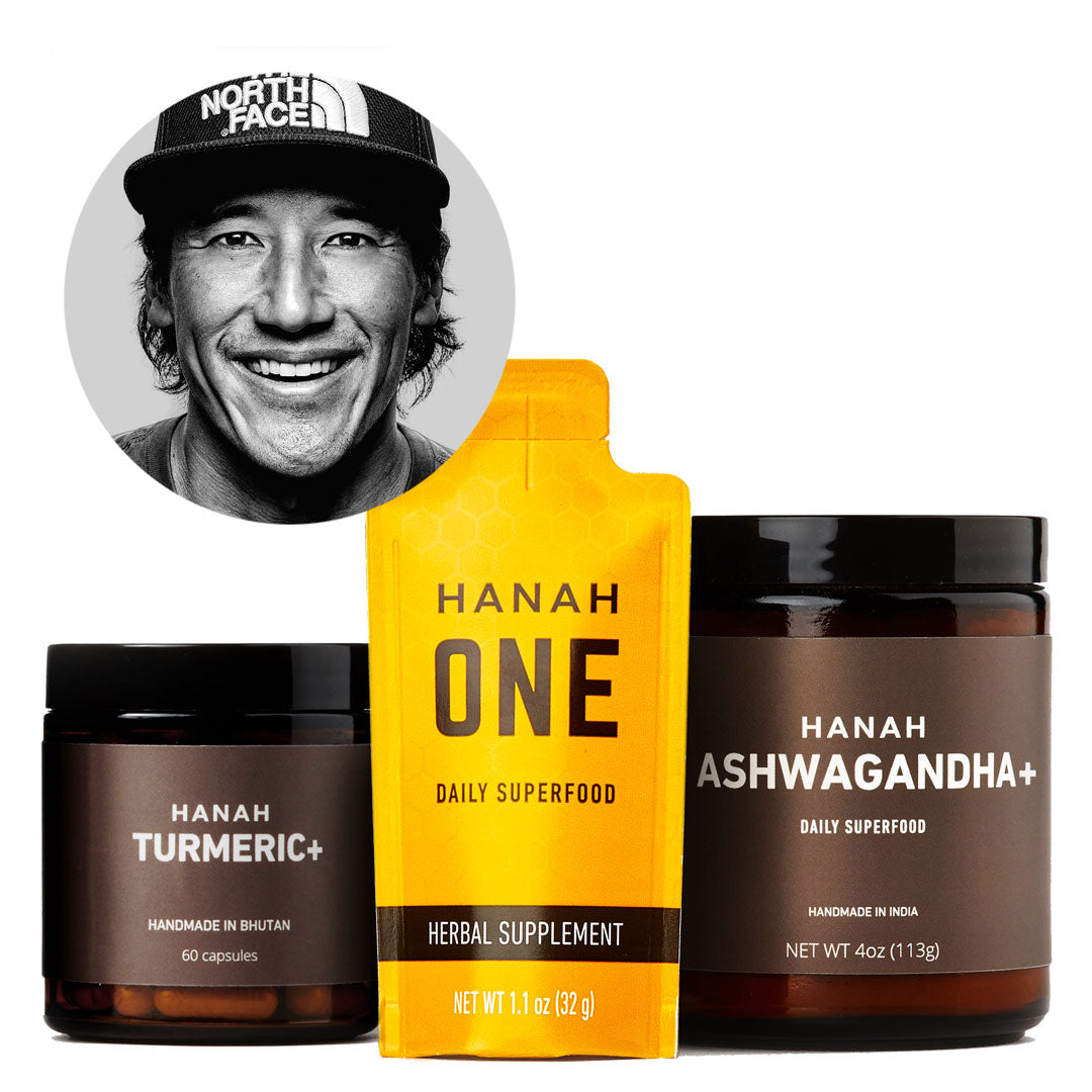 A jar of HANAH Turmeric, a HANAH ONE Go-Pack, and a jar of HANAH Ashwagnahda sit side by side on a white background. A circular portrait photo of Jimmy Chin is in the top left of the image to indicate that these three products are favorites of his. Together, these three product are the HANAH Jimmy Chin Signature Series product bundle. 